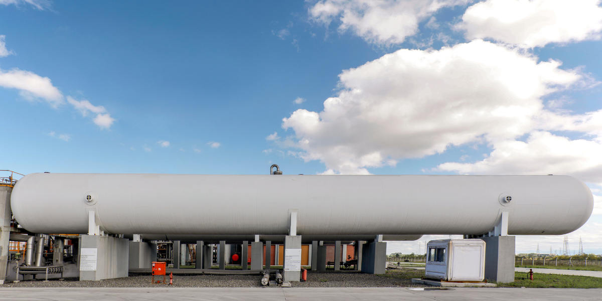A large scale cryogenic insulation tank in front of a clear sky